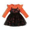 A long-sleeved girls' Halloween dress with a bright orange top, ruffle shoulders, and a black tulle skirt featuring a spooky cat-pumpkin face on the bodice.