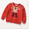 A soft, bright red knitted children's Christmas jumper featuring a funny, upside-down cartoon reindeer with a fluffy red pom-pom for a nose.