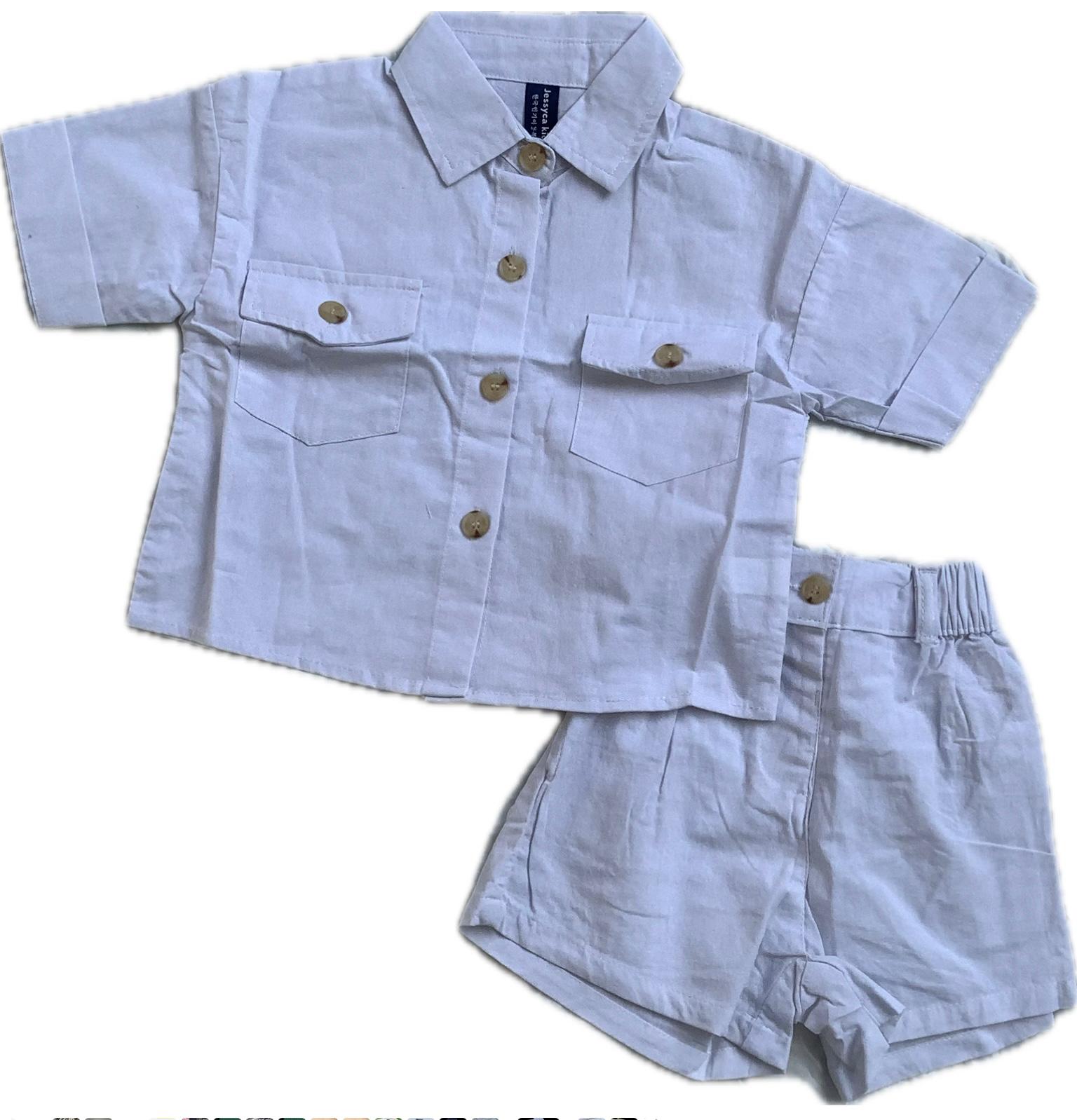 A smart unisex children's two-piece summer outfit in a crisp white linen-blend, featuring a short-sleeved collared shirt with pockets and matching shorts with an elasticated waist.