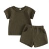 A unisex baby and toddler waffle-knit loungewear set in a deep dark brown colour, including a short-sleeved top and matching shorts with pockets.