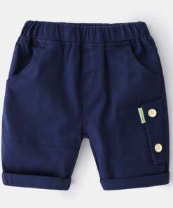 A pair of smart navy blue cotton shorts for a boy, featuring a comfortable pull-on elasticated waist, roll-up cuffs, and a button-down cargo pocket on the leg.