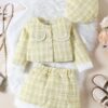 A chic three-piece girls' outfit in a soft yellow tweed, featuring a jacket and skirt trimmed with white faux fur, and a matching tweed beret.