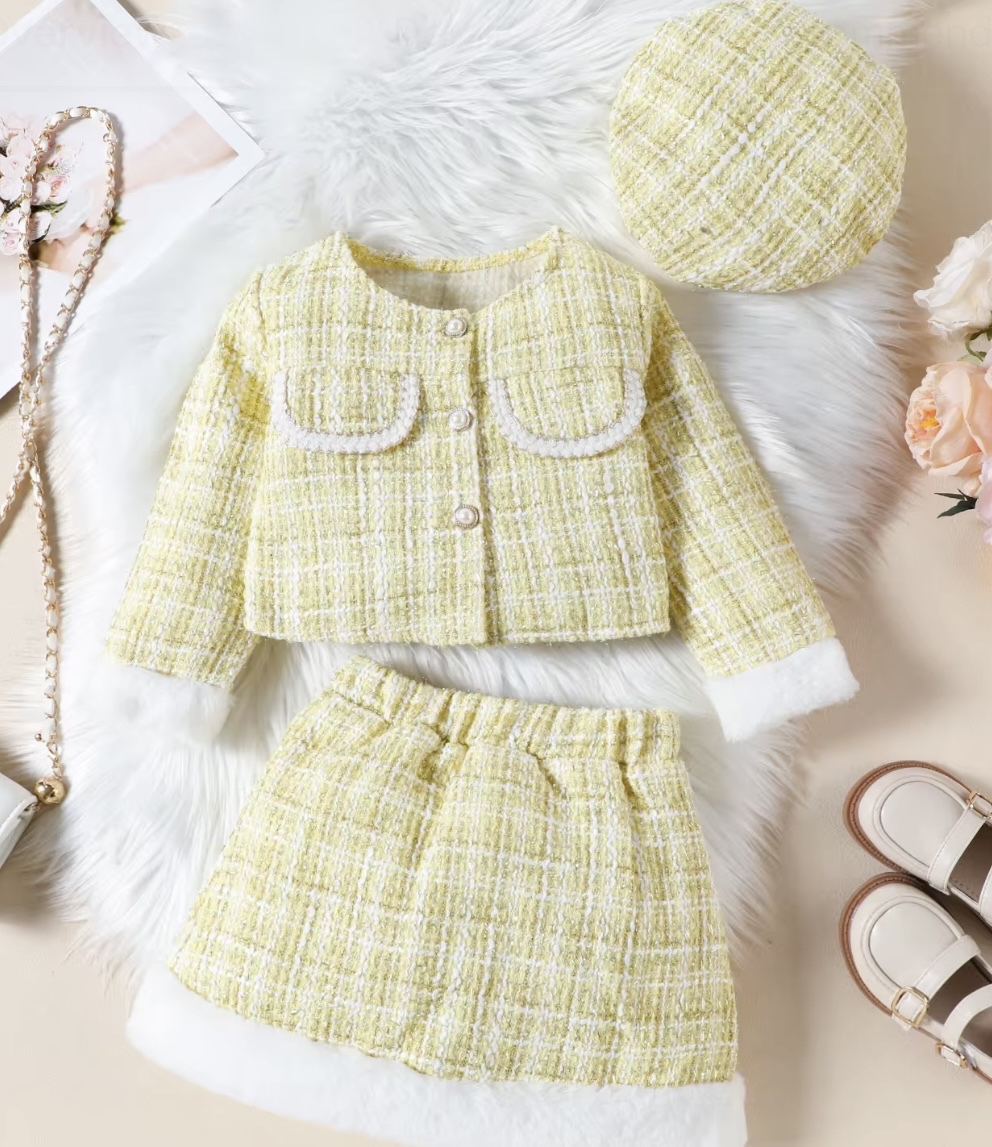 A chic three-piece girls' outfit in a soft yellow tweed, featuring a jacket and skirt trimmed with white faux fur, and a matching tweed beret.